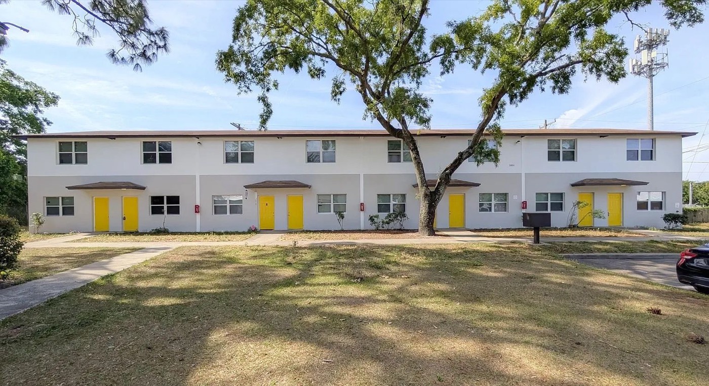 Row of white townhomes with yellow doors at Yellow Pine
