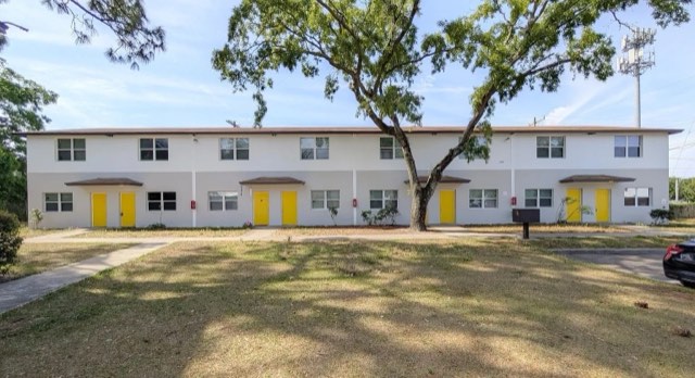 White townhomes with yellow doors